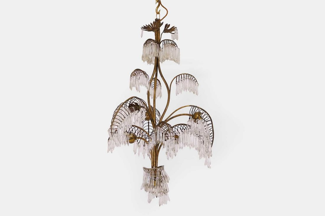 A brass seven-light chandelier, 20th century,: A brass seven-light chandelier, 20th century, with cut-glass droplets and all-over foliage and scroll detail (67cm wide, 96cm high) Provenance: The Richard Collins Collection. Condition Report: Struct