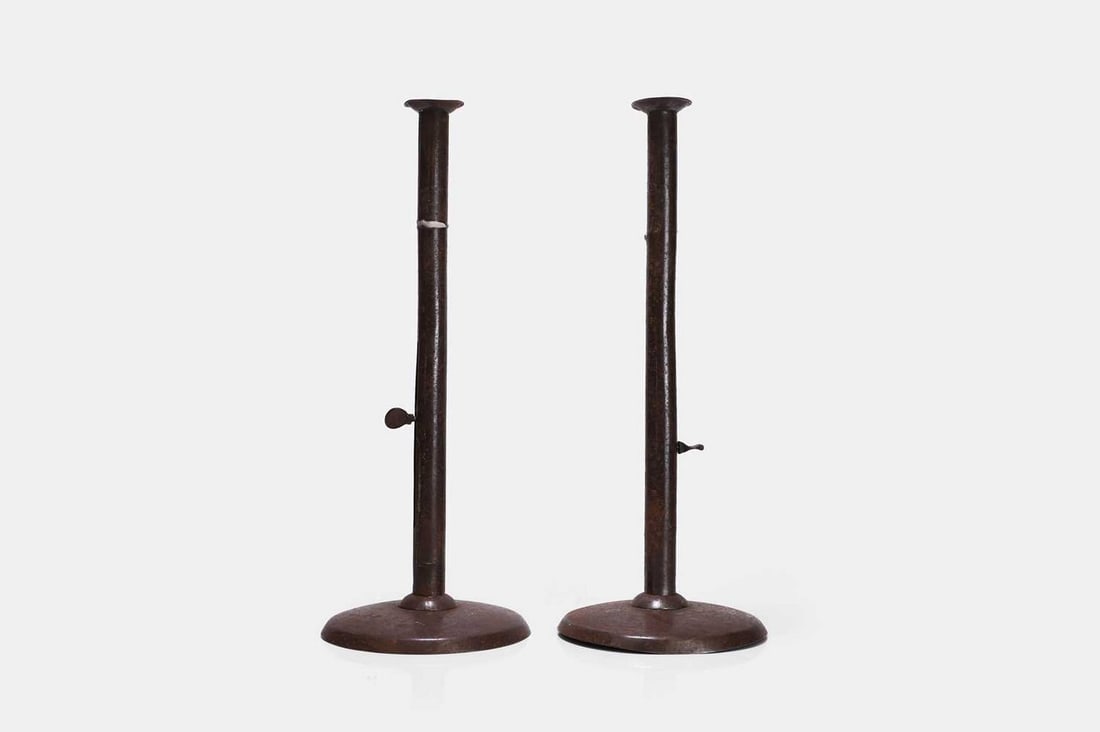 A pair of 'hogscraper' sheet-iron ejector candlesticks, 19th century, (1 of 3)