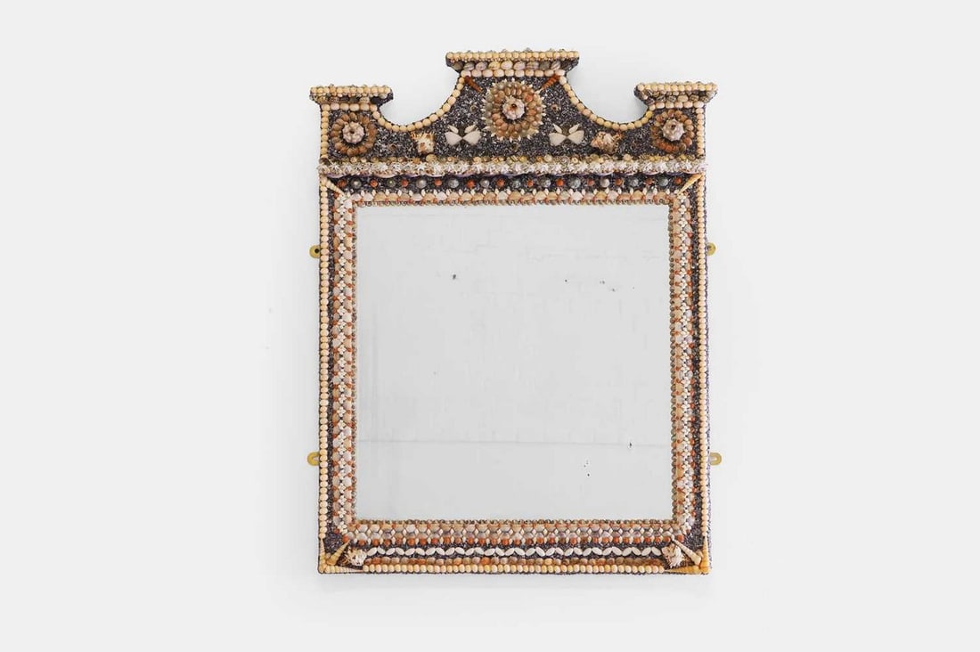 A shellwork mirror, of recent manufacture, incorporating earlier elements,: A shellwork mirror, of recent manufacture, incorporating earlier elements, with a broken pediment over a rectangular bevelled glass plate (77cm wide, 104cm high) Condition Report: Very light wear to t