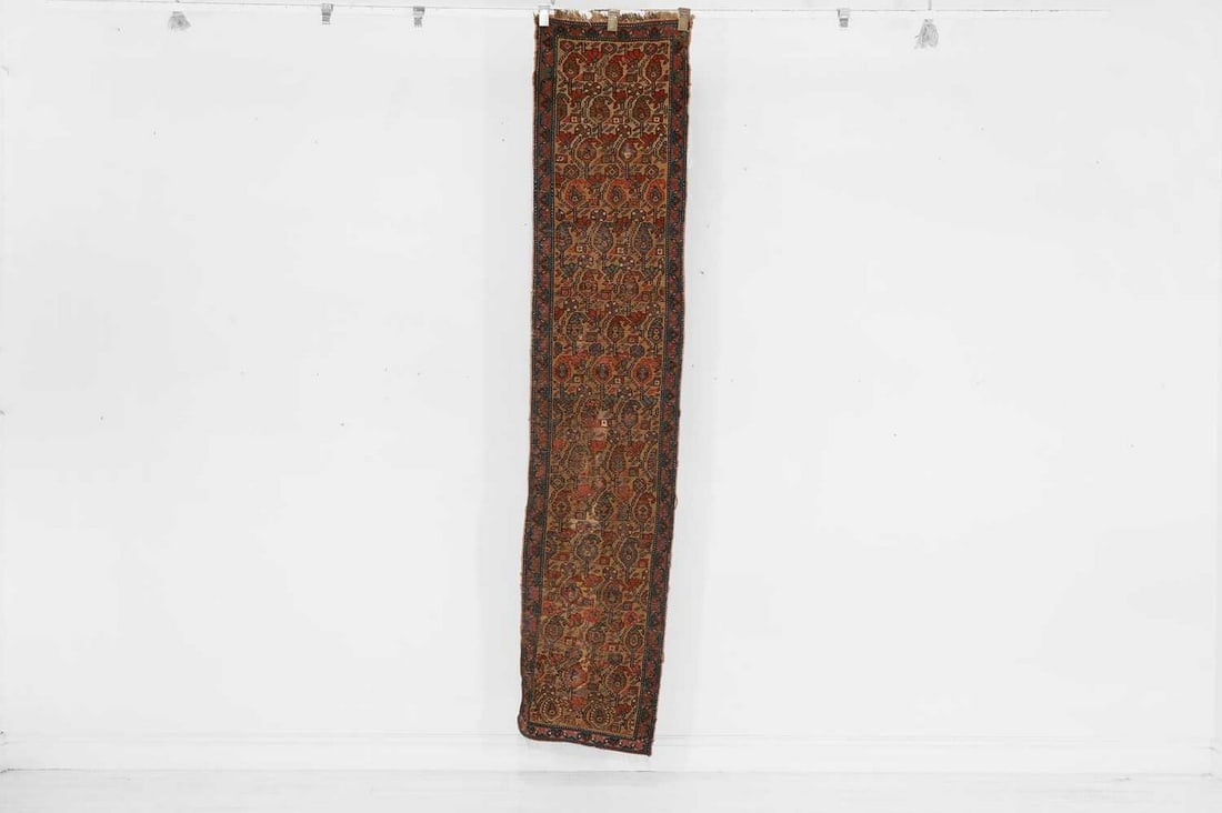 A Persian Heriz wool runner, early 20th century,: A Persian Heriz wool runner, early 20th century, the pale field woven with paisley motifs, within a dark blue border (240 x 52cm) Provenance: Donnington Castle House, Newbury, Berkshire. Condition Rep
