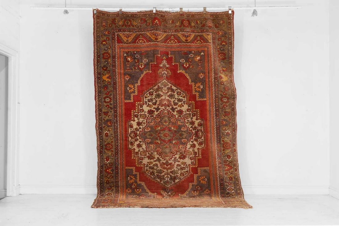 A tribal wool carpet, 20th century,: A tribal wool carpet, 20th century, centred by a medallion and spandrels, with all-over polychrome detail (315 x 187cm) Provenance: Donnington Castle House, Newbury, Berkshire. Condition Report: Good