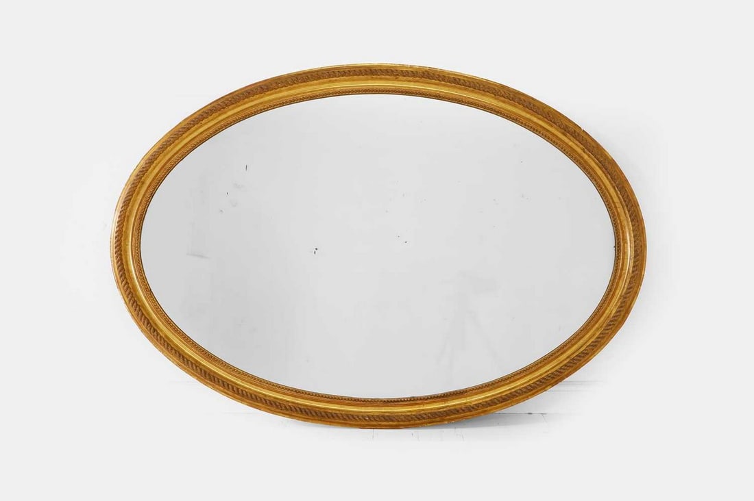 A large carved giltwood and gesso oval mirror, 19th century, (1 of 3)