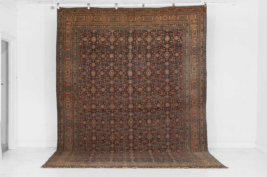 A Persian wool carpet, early 20th century, (1 of 4)