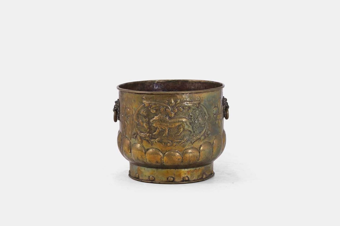 A large brass coal or log bin, late 19th/early 20th century, Dutch,: A large brass coal or log bin, late 19th/early 20th century, Dutch, with all-over repoussé decoration featuring eagles, lions, and fleur-de-lys motifs, set with a pair of loop handles and a gadro