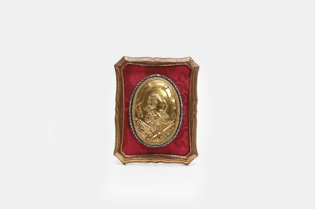 A Louis XVI gilt-bronze double-profile portrait relief plaque or badge, late 18th century, French,: A Louis XVI gilt-bronze double-profile portrait relief plaque or badge, late 18th century, French, of oval form, depicting Marie Antoinette and Louis XVI supported by a trophy of arms, set with a past