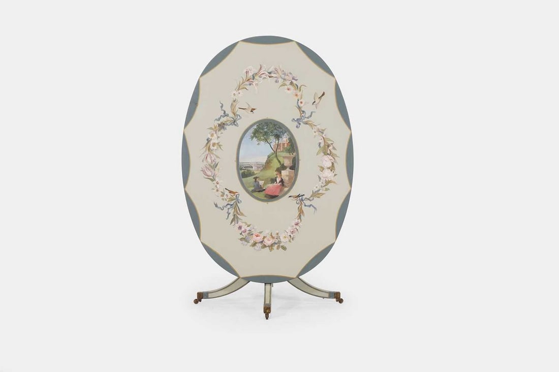 ▲ Michael Dillon (Irish, b.1957), a George III-style painted wooden centre table,: ▲ Michael Dillon (Irish, b.1957), a George III-style painted wooden centre table, 20th century, the oval top centred with figures seated in Greenwich Park, within a floral garland border, raised