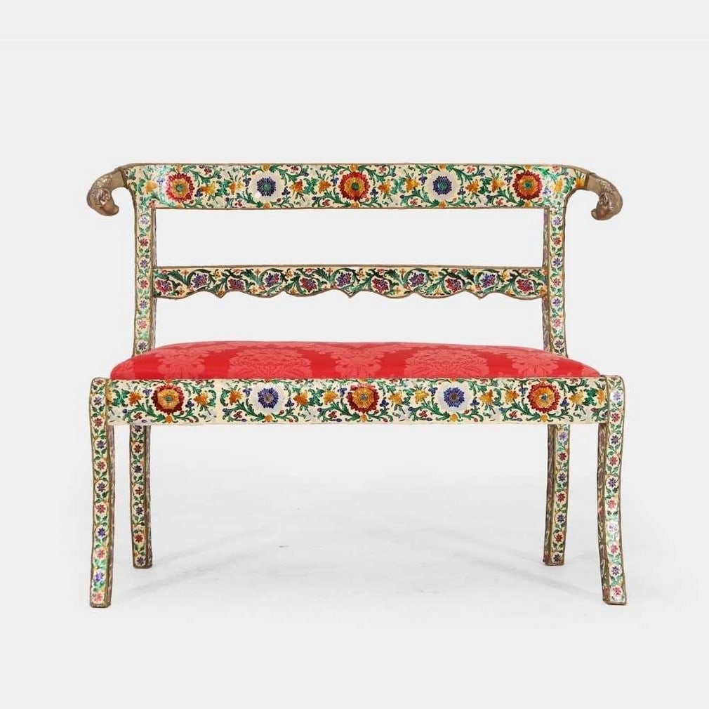 A silver-metal and enamel-clad settee in the Regency style, 20th century, Indian,: A silver-metal and enamel-clad settee in the Regency style, 20th century, Indian, the bar back set with a pair of ram's head terminals, above a drop-in seat upholstered in red silk damask, raised on s