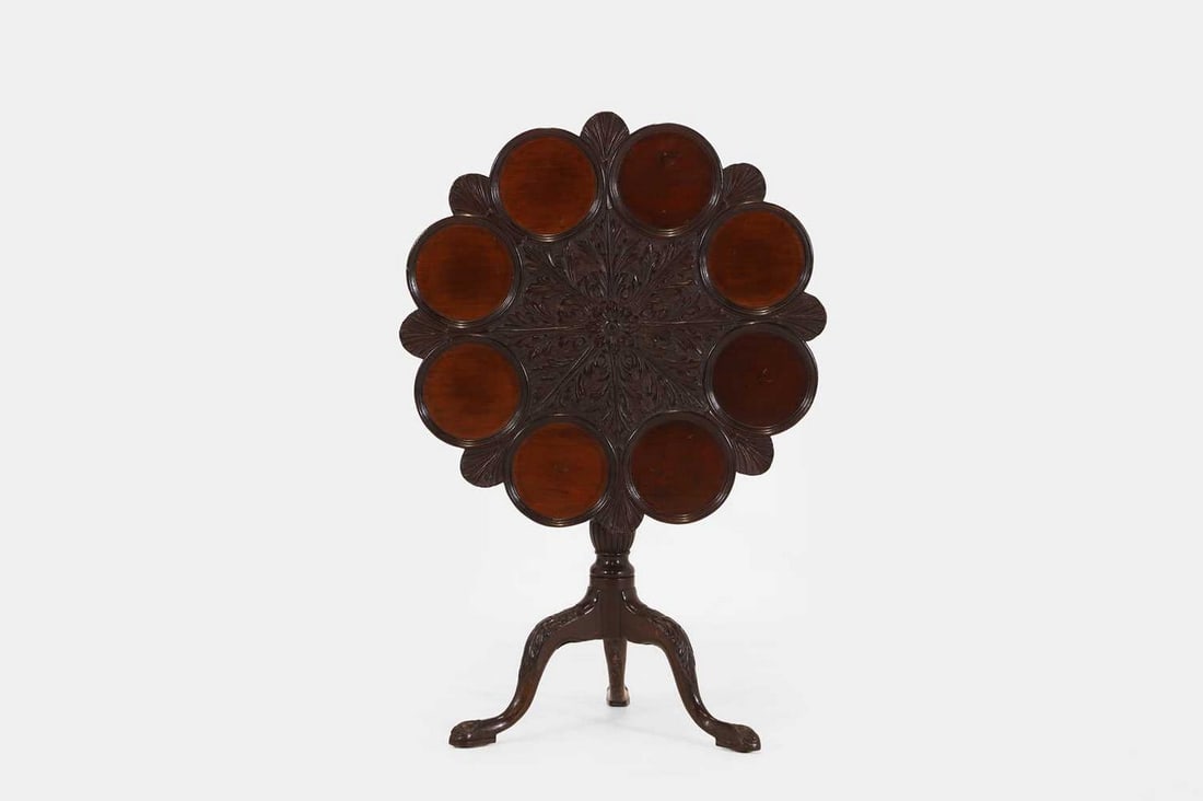 A George II-style mahogany supper table, c.1880,: A George II-style mahogany supper table, c.1880, the carved top, with eight dished sections and shell-carved detail, raised on a turned column with a birdcage action, with a carved tripod base (74.5cm