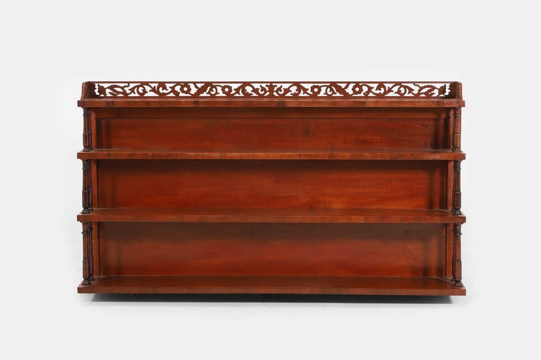 A Regency mahogany hanging waterfall bookcase, early 19th century,: A Regency mahogany hanging waterfall bookcase, early 19th century, with a fretwork gallery above four graduated shelves, on ring-turned supports (107cm wide, 19cm deep, 58cm high) Condition Report: Cl