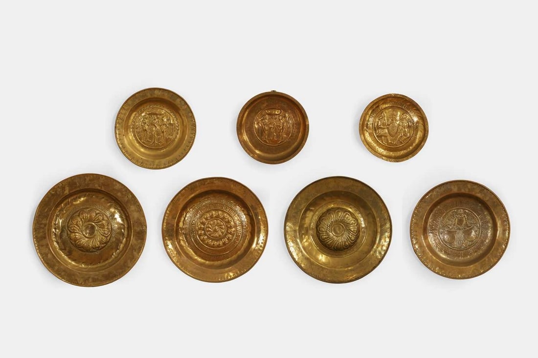 A collection of seven brass alms dishes, probably 16th century or later, Continental,: A collection of seven brass alms dishes, probably 16th century or later, Continental, all with repoussé design, including some depicting Adam and Eve (largest 47cm diameter, smallest 28cm diamete