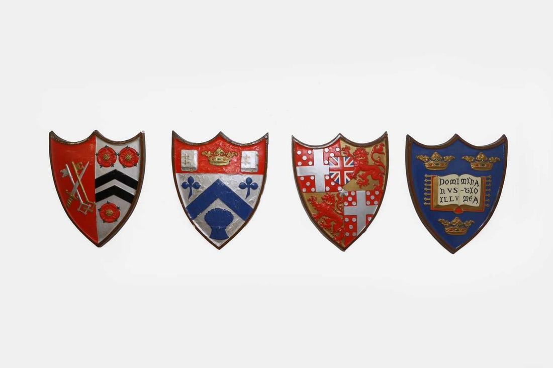 Four painted plaster armorial shields, early 20th century,: Four painted plaster armorial shields, early 20th century, each bearing a coat of arms comprising Winchester College, Clifton College, Wellington College and the University of Oxford (53 x 42cm) (4) C