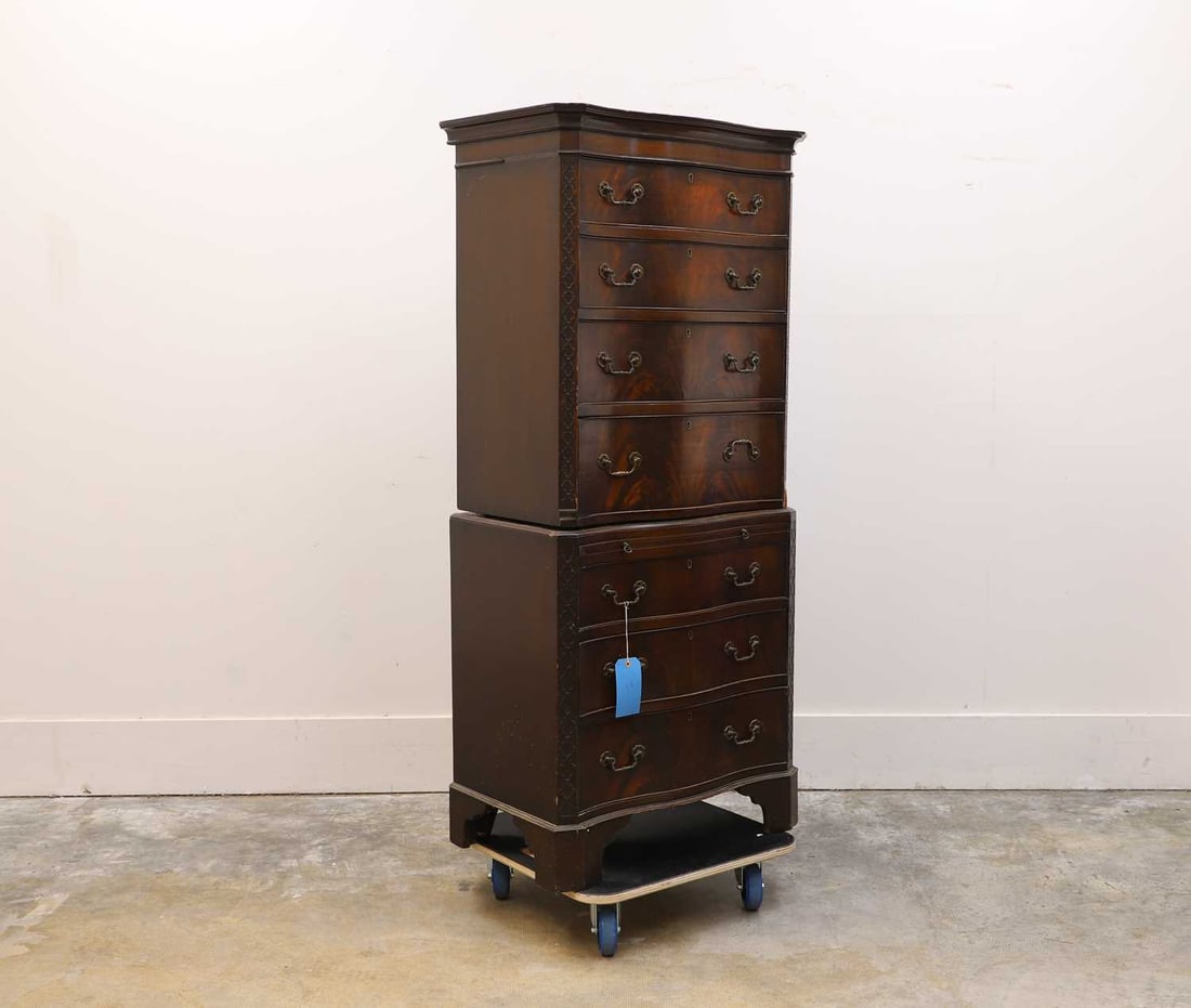 A flame mahogany serpentine chest on chest, 19th century,: A flame mahogany serpentine chest on chest, 19th century, with cross-hatched moulding to the sides, comprising of an arrangement of seven long drawers and a brushing slide, terminating on canted