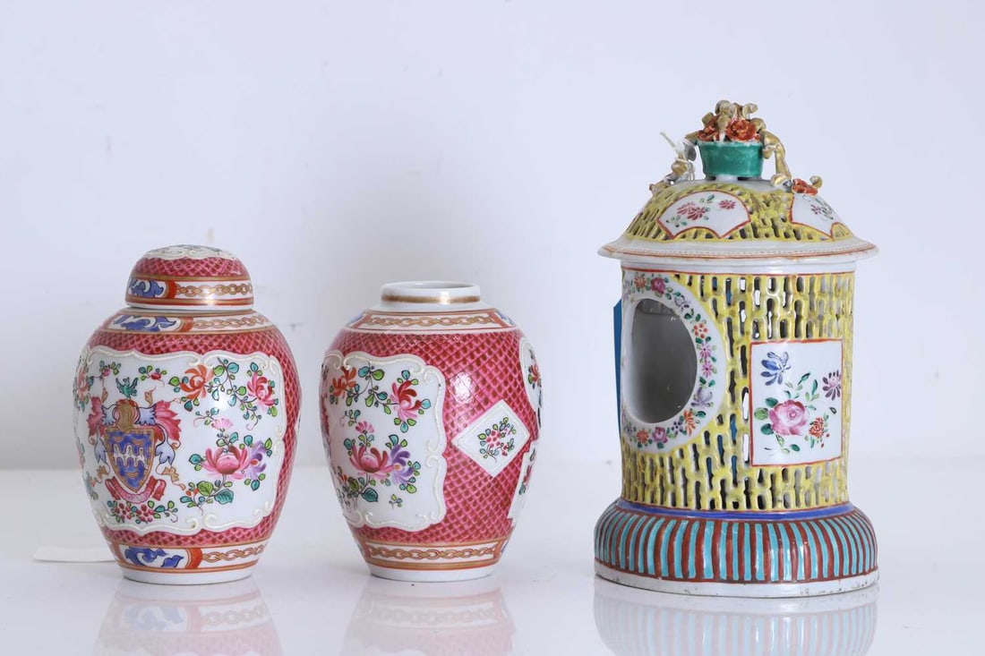 A pair of Samson Armorial ginger jars, 19th century,: A pair of Samson Armorial ginger jars, 19th century, each of ovoid form, one with domed cover, enamelled in famille rose colours with a central armorial crest within elaborate mantling, flanked by