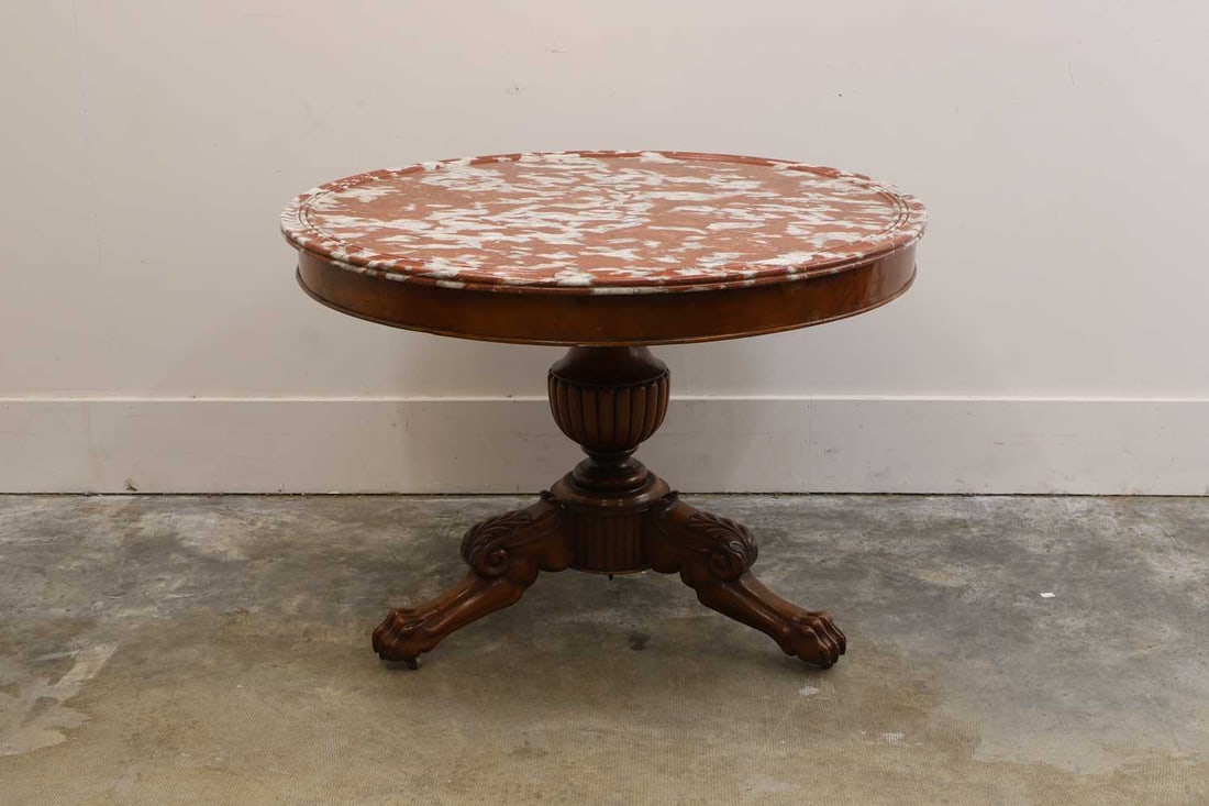 A Charles X mahogany guéridon, c.1835, French,: A Charles X mahogany guéridon, c.1835, French, with a circular rouge marble top, raised on a tripod base with knee-carved supports terminating in paw feet 103cm diameter, 75cm high