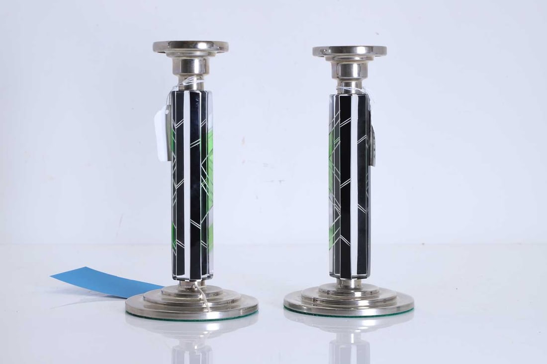 A pair of Art Deco candlesticks, 20th century,: A pair of Art Deco candlesticks, 20th century, in the manner of Karel Palda, probably Czechoslovakian, each with a circular silver-plated base and nozzle, the tapering hexagonal glass stem inset