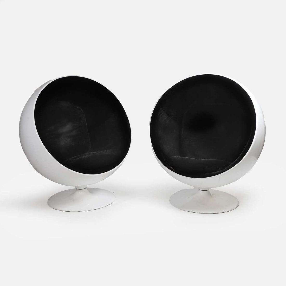 After Eero Aarnio, a pair of ball chairs,: After Eero Aarnio, a pair of ball chairs, originally designed in 1963, the fibreglass and aluminium ball frames, on swivel bases with black velvet upholstery 100cm wide, 90cm deep, 123cm high 