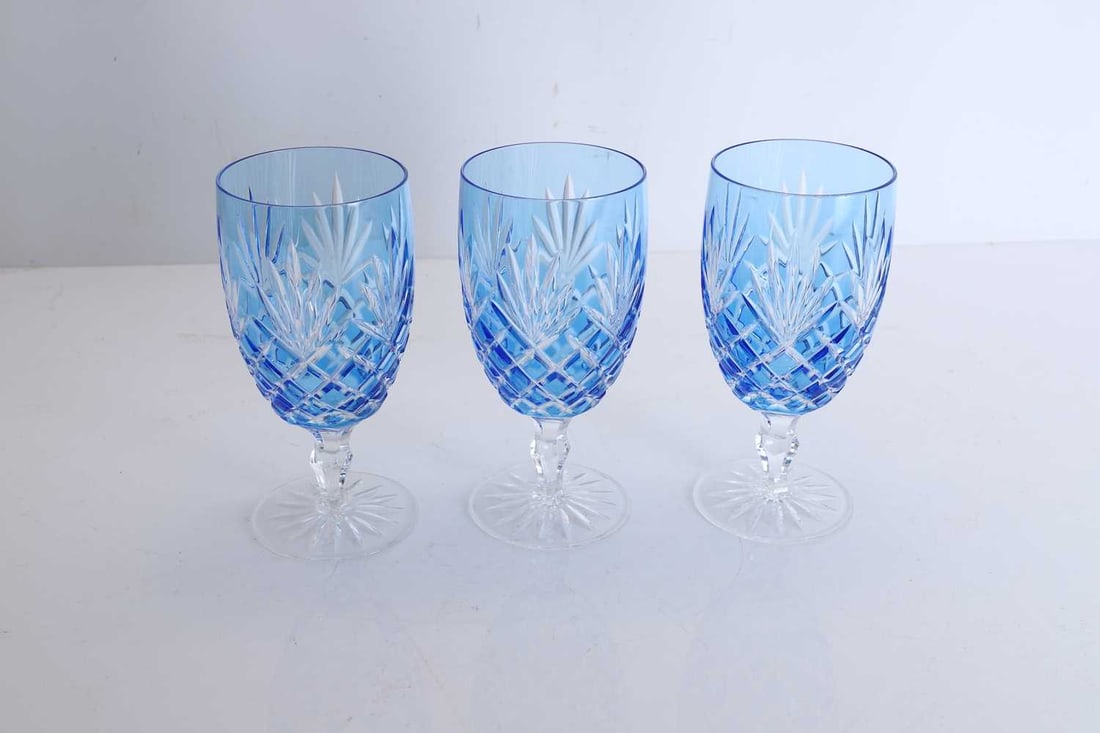 A group of three Faberge Odessa light blue iced goblets, 20th century,: A group of three Faberge Odessa light blue iced goblets, 20th century, with a cut glass design, stamped makers mark to the base 8.9cm diameter, 18cm high 3
