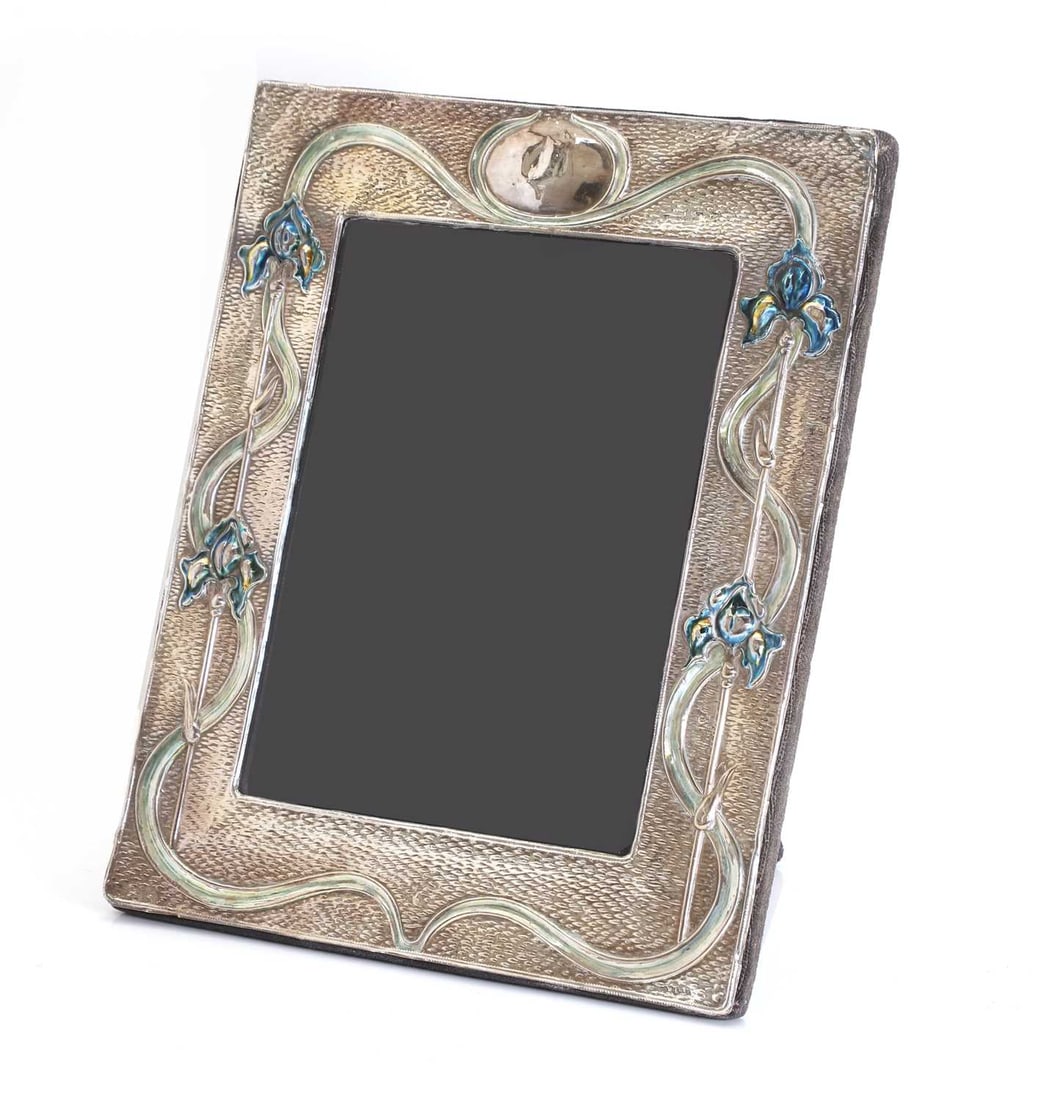 A silver Art Nouveau style picture frame, 20th century,: A silver Art Nouveau style picture frame, 20th century, by Ray Hall, Birmingham, 1994, with enameled blue and yellow iris to the frame, and planished ground 29 x 24cm, total, 21.7ozt