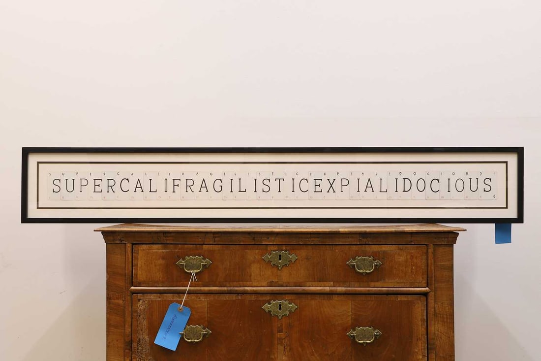 A vintage playing card picture, of recent manufacture,: A vintage playing card picture, of recent manufacture, spelling out the word 'Supercalifragilisticexpialidocious', framed framed, 156 x 23.5cm Condition Report: Some slight browning to the cards