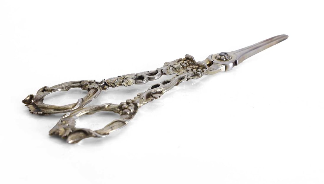 A pair of cast silver grape scissors,: A pair of cast silver grape scissors, London, 1867, stamped 'P.H', the handles with moulded grape vine decoration 19cm long, 3.1ozt