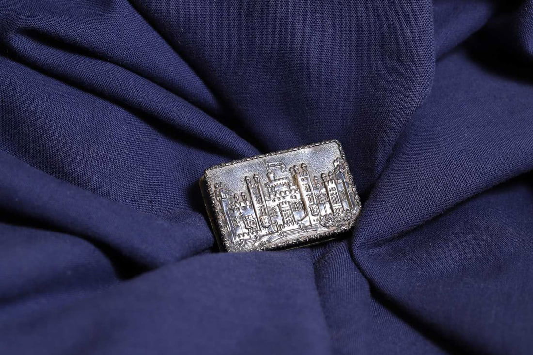 A silver 'Castle Top' vinaigrette,: A silver 'Castle Top' vinaigrette, by Nathaniel Mills, Birmingham, c.1835, cast with a view of Windsor Castle, complete with a gilt interior and pierced grille 4.1cm wide, 2.8cm