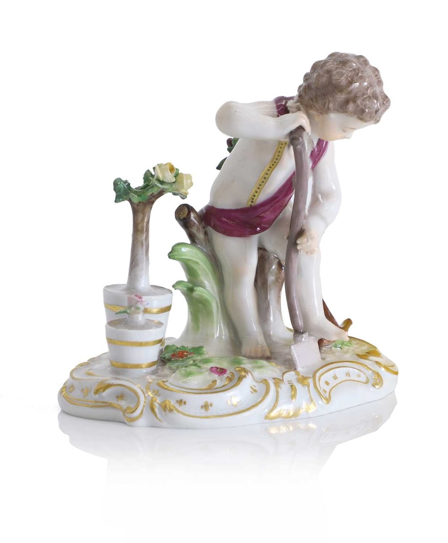 A Meissen figure of a putto gardener, 19th century,: A Meissen figure of a putto gardener, 19th century, modelled wearing a draped puce sash, standing barefoot upon a naturalistic base, holding a long handled spade and digging, beside him flowering