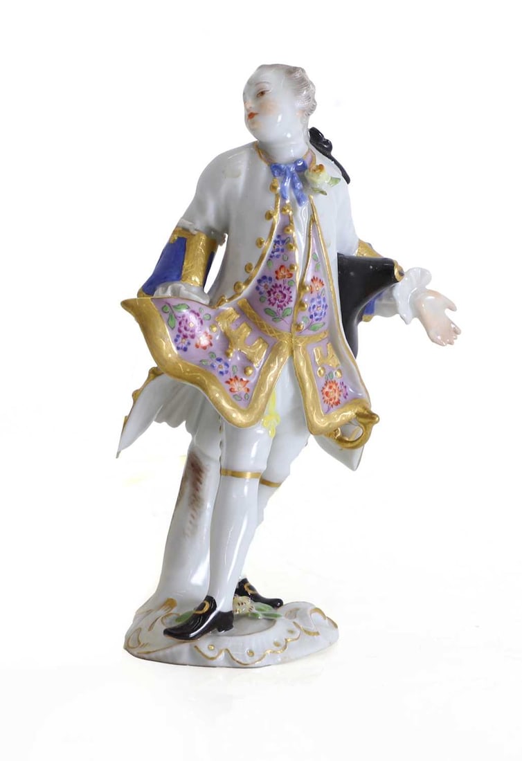 A Meissen figure of a gentleman, circa 1900,: A Meissen figure of a gentleman, circa 1900, with a tricorn hat under his arm and a white overcoat, with blue cross swords to the base, and incised marks '33' and '1490' 8cm wide, 11.5cm high