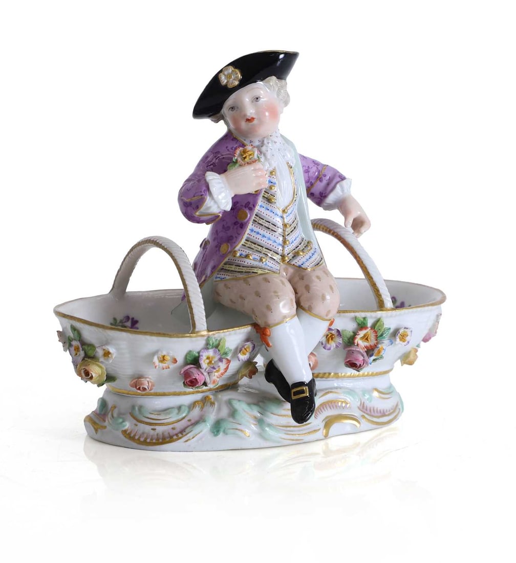 A Meissen figural double salt, 19th century,: A Meissen figural double salt, 19th century, modelled as a gallant between two salts with rope twist handles, the gentleman wearing a black tricorn hat with gilt rosettes, puce coat, striped