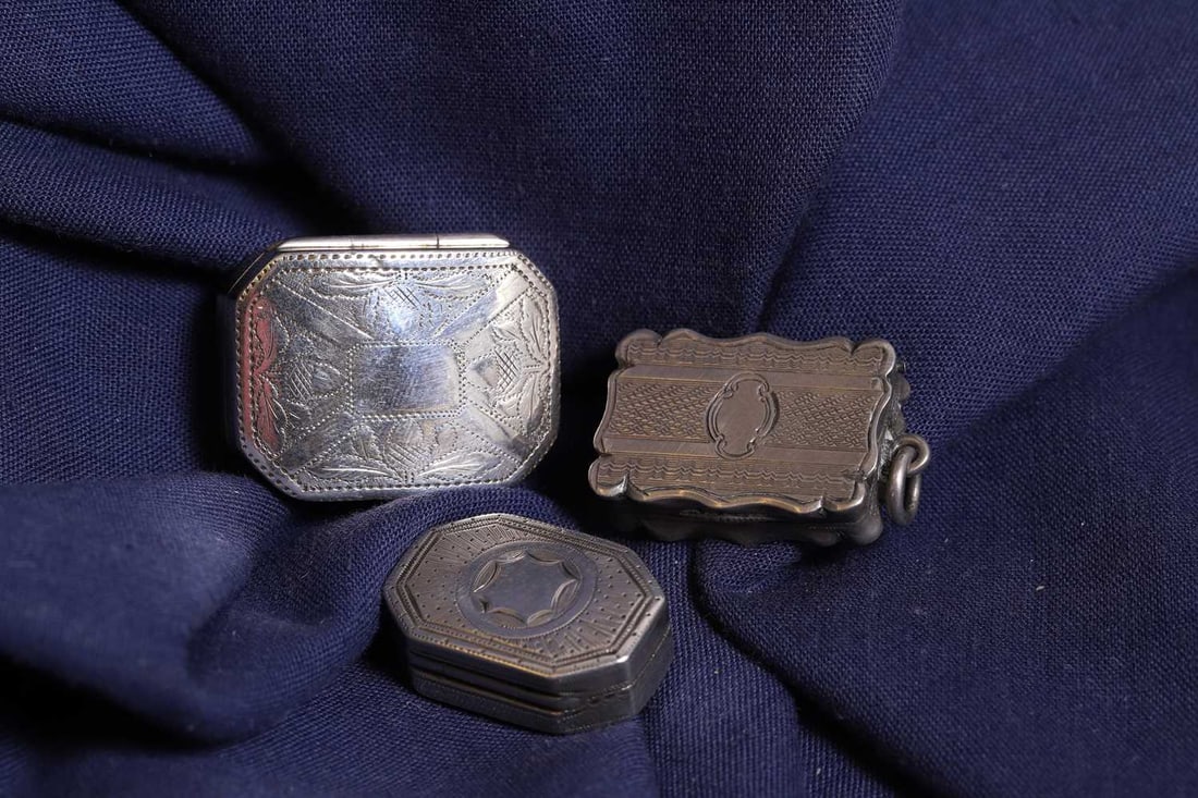 A group of three silver vinaigrettes,: A group of three silver vinaigrettes, comprising a Victorian example, by James Fenton, Birmingham 1858, a similar example, by Samuel Pemberton, Birmingham 1801, and a larger example, by Samuel