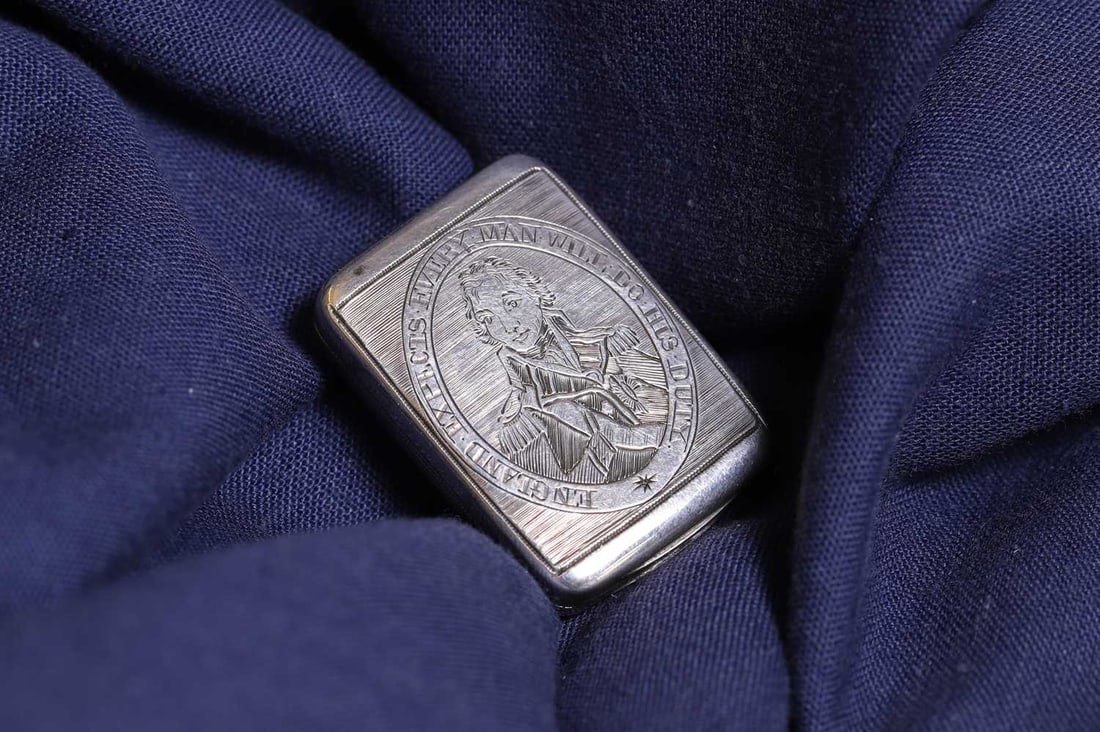 A George III commemorative Nelson silver vinaigrette,: A George III commemorative Nelson silver vinaigrette, by Matthew Linwood, Birmingham 1805, the hinged cover chased with an engraved portrait of Nelson within a border inscribed 'England Expects