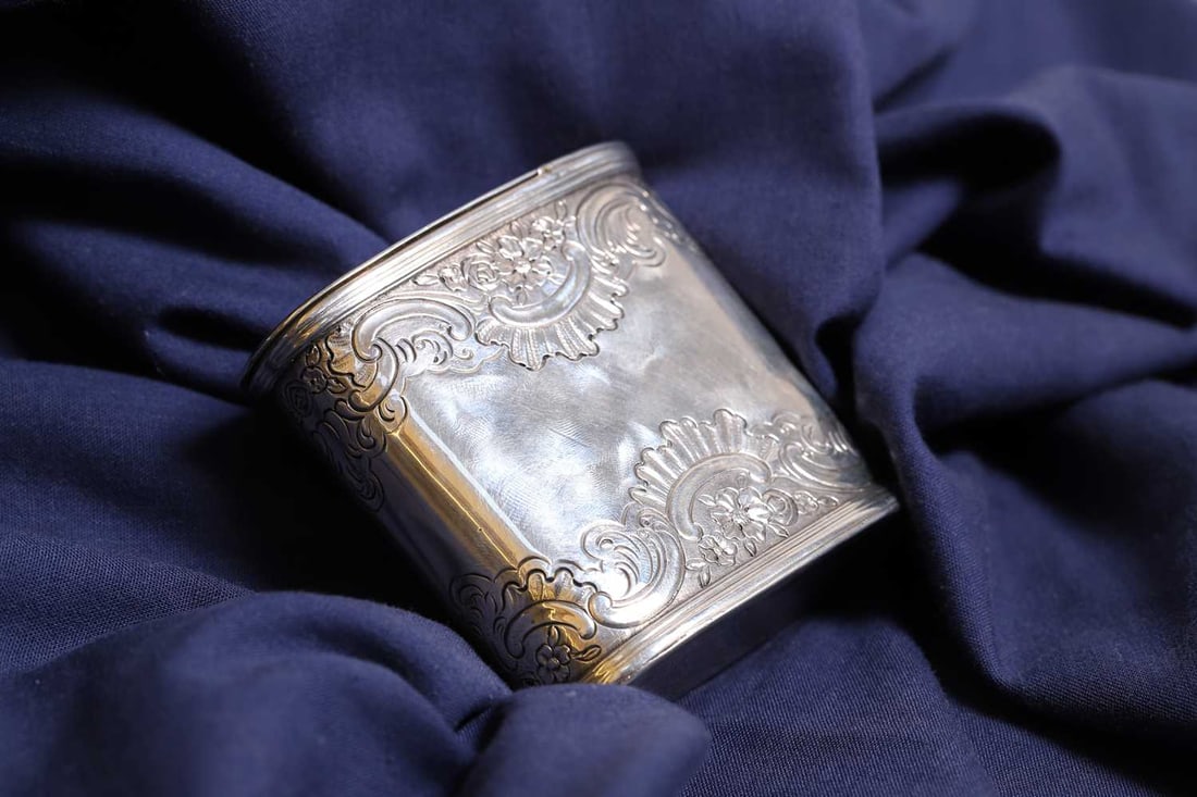 A George II Scottish silver snuff mull,: A George II Scottish silver snuff mull, c.1750, by James Mitchell of Edinburgh, of 'upright' form, with chased scrolling decoration, complete with a gilt interior 8.1cm wide, 3.2cm