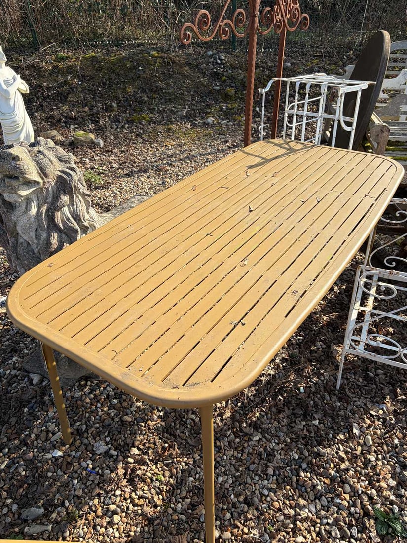 An outdoor dining table, Of recent manufacture,: An outdoor dining table, Of recent manufacture, finished in a powder coated dijon yellow, a flat, slatted top over four straight tube supports 83cm wide 180cm long Condition Report: Some