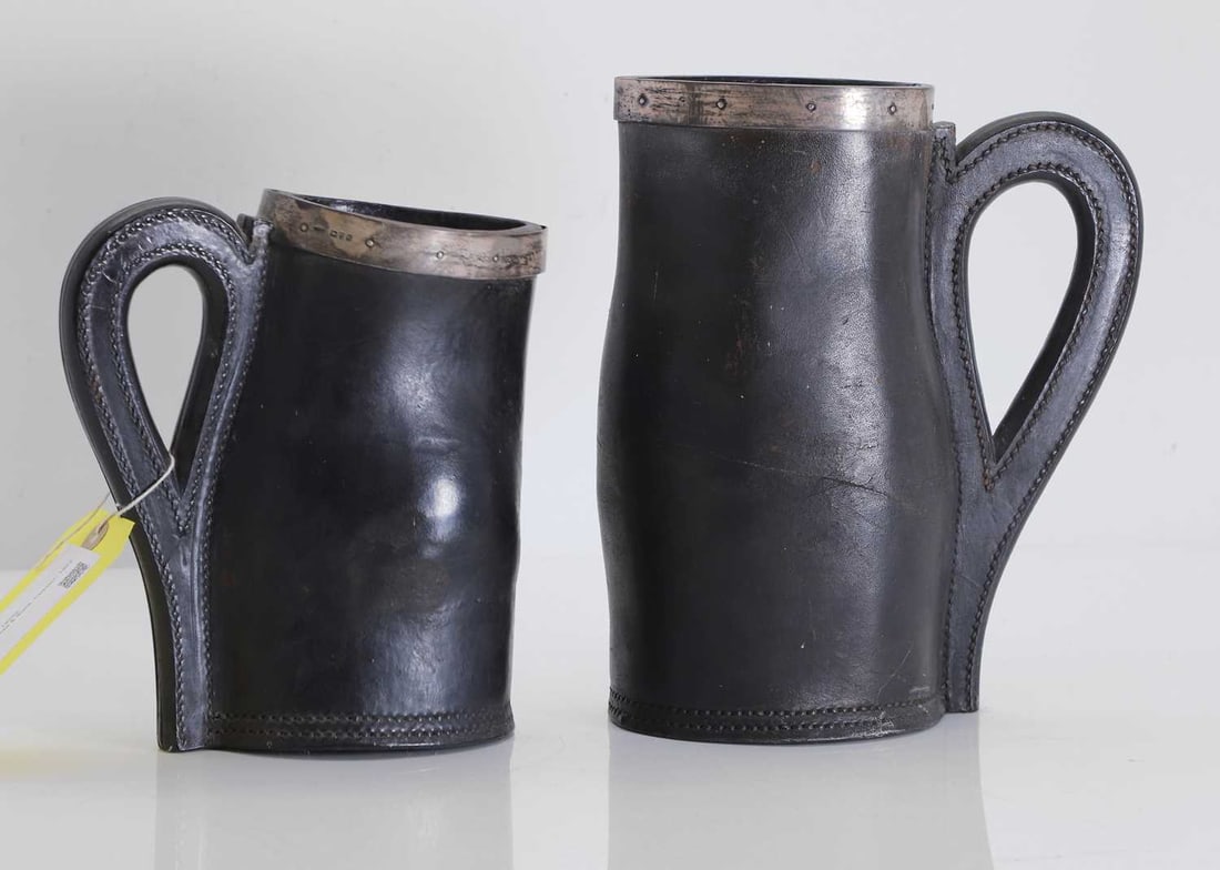 Two silver mounted leather jacks, circa 1920s,: Two silver mounted leather jacks, circa 1920s, with silver mounts, the larger by F J Ross & Sons, Chester, 1922 and 1925 24cm and 19cm high 2 Condition Report: Tarnished silver.