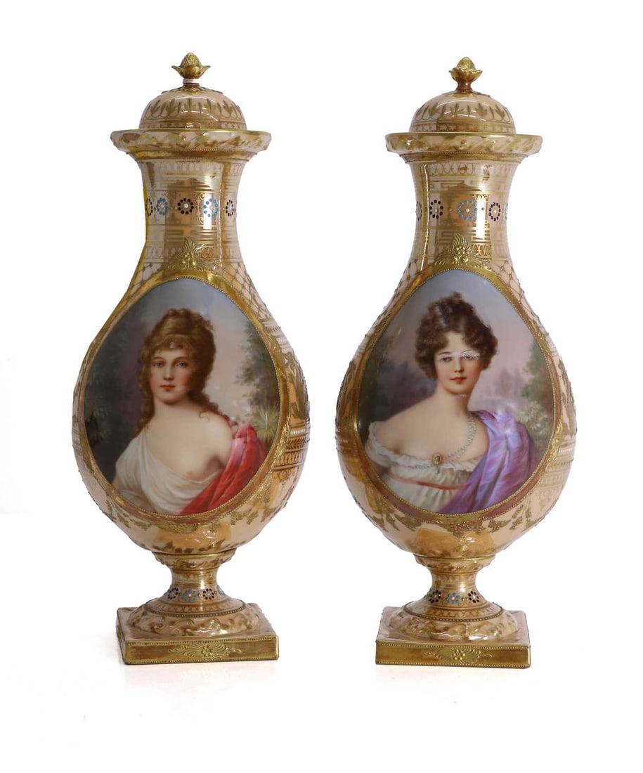 A pair of Vienna squat pedestal baluster lidded vases, second half of the 19th century,: A pair of Vienna squat pedestal baluster lidded vases, second half of the 19th century, both painted with portraits of young women with a wooded landscape behind, with scrolling low relief
