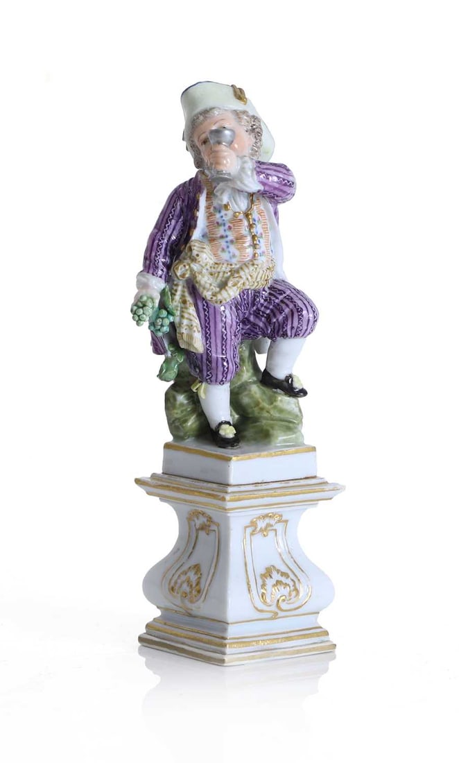A Meissen figure of a boy with a wine goblet, emblematic of Autumn, late 19th century,: A Meissen figure of a boy with a wine goblet, emblematic of Autumn, late 19th century, modelled as a young boy upon a rocky mound rasing a goblet of wine his right hand, and holding a cluster of