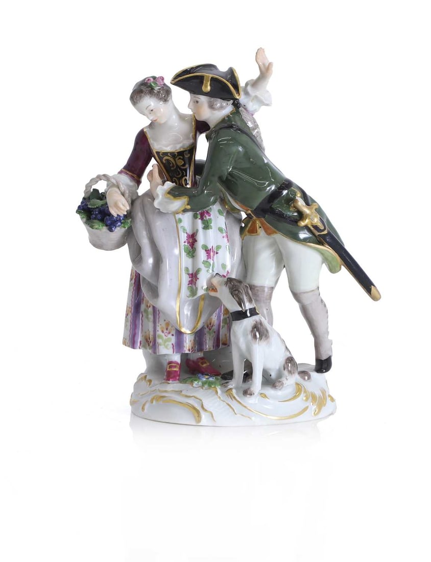A Meissen group of a courting couple with attendant hound, 19th century,: A Meissen group of a courting couple with attendant hound, 19th century, the gentleman holding the lady who is carrying a basket full of grapes, with blue cross swords to the base, and incised marks