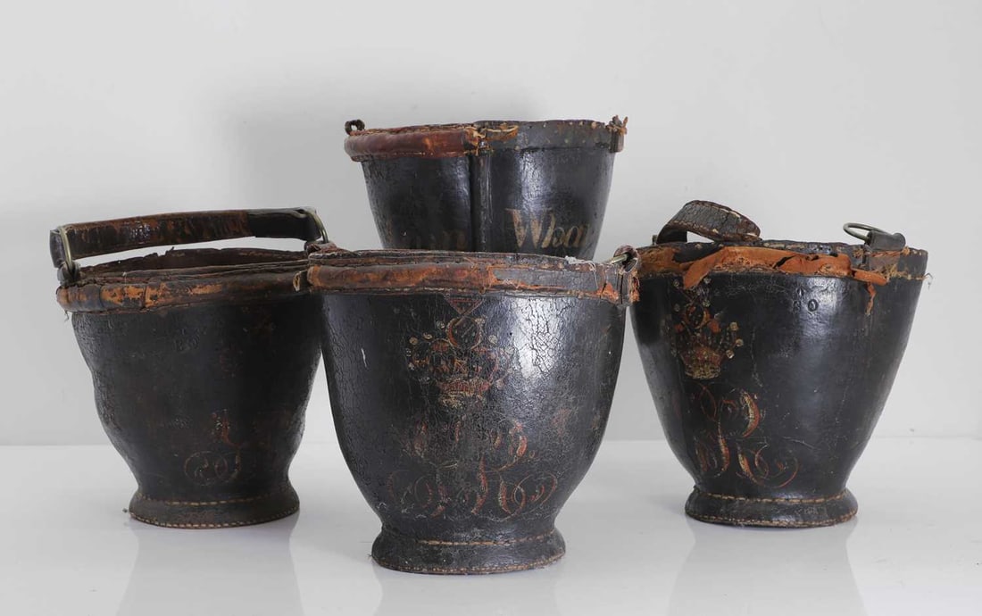 A collection of four leather fire buckets, 18th century / 19th century,: A collection of four leather fire buckets, 18th century / 19th century, each painted with 'GR' cipher below a crown, the reverse 'Gun Wharf', each stamped 'BO' below, an arrow, for Board of
