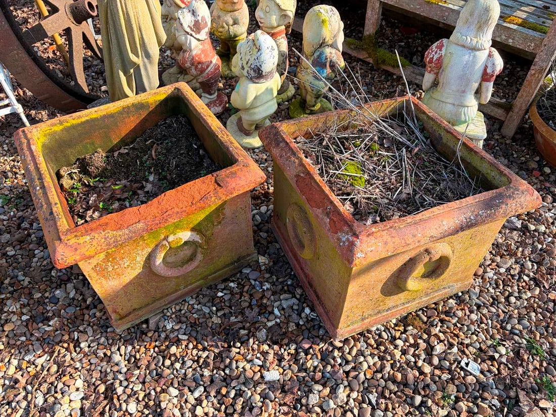 A pair of square terracotta planters, 20th century,: A pair of square terracotta planters, 20th century, with moulded edge, faux handles on all four sides 52cm wide 41cm high 2 Condition Report: Quite degraded and loss to the sides. Crumbly