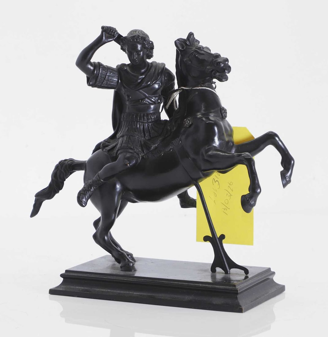 A bronze of Alexander the Great on Bucephalus, circa 1900,: A bronze of Alexander the Great on Bucephalus, circa 1900, modelled with his sword raised, his horse on its hind legs, on a shaped plinth 25.5cm wide, 12cm deep, 27cm high Condition Report: Fair