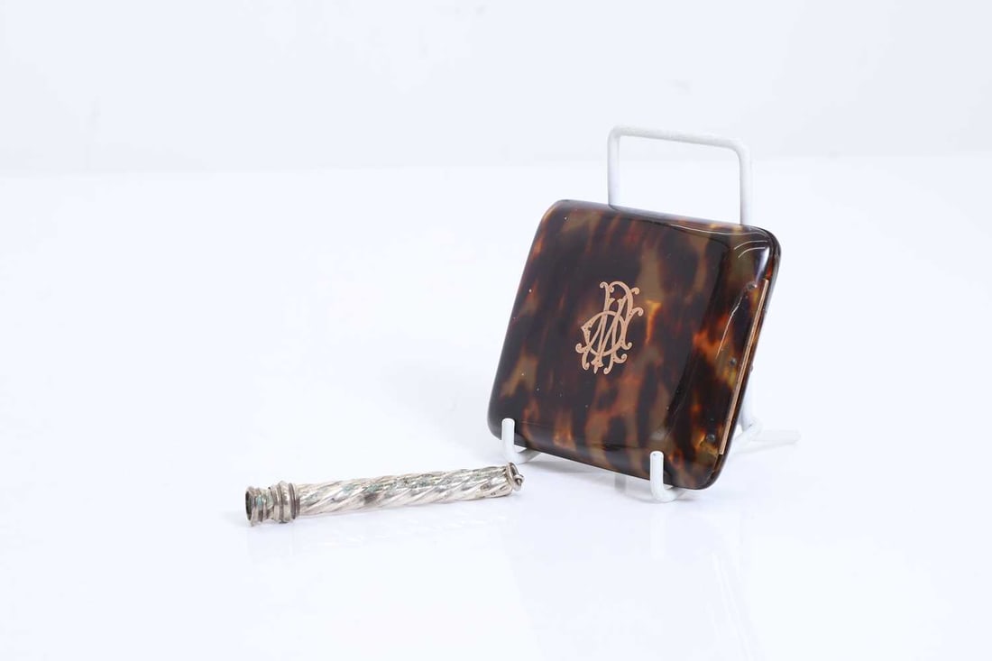 A tortoiseshell and rose gold inlaid cigarette case,: A tortoiseshell and rose gold inlaid cigarette case, together with silver propelling pencil case, Cigarette case, 8.5 x 8cm 0.3ozt Condition Report: Case with crack.