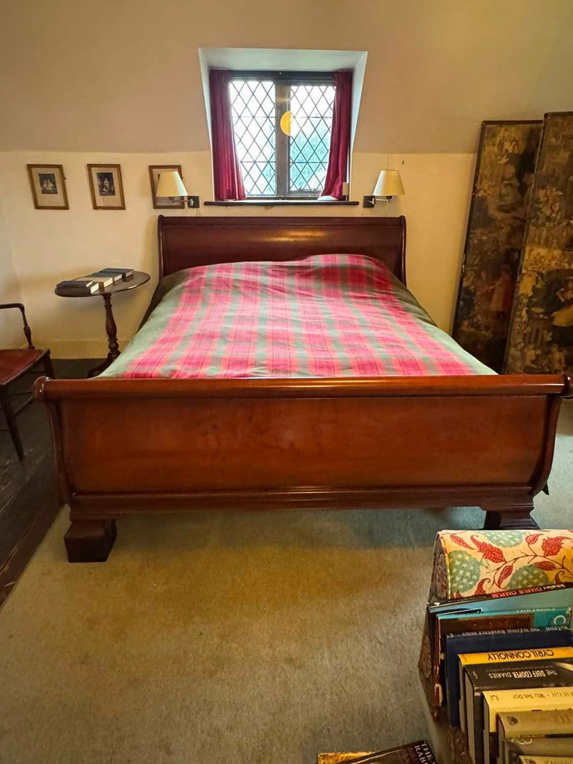 A cherrywood sleigh bed frame, 20th century,: A cherrywood sleigh bed frame, 20th century, with two sets of slats, headboard and a baseboard 177cm wide, 222cm long approx Condition Report: Dismantled for sale, with a box of pieces and bolts.