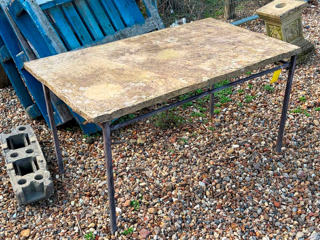 A stone and iron table, of recent manufacture,: A stone and iron table, of recent manufacture, on four square legs, with lower rectangular support, the top a flagstone slab 132cm wide 77cm deep 71cm high