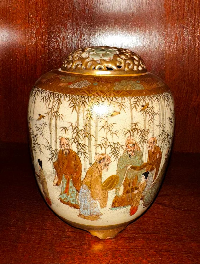 A Japanese satsuma pot pourri vase and cover, early 20th century,: A Japanese satsuma pot pourri vase and cover, early 20th century, of oviform shape, decorated in enamels and gilt and painted with figures amongst bamboo, the openwork cover decorated with flowers,