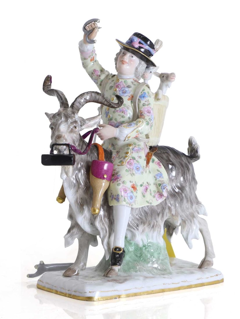A Meissen porcelain figure group of Count Bruhl's tailor, 19th century, after the 18th century origi: A Meissen porcelain figure group of Count Bruhl's tailor, 19th century, after the 18th century original, modelled as the tailor astride a goat, wearing a black hat with plumes and a long pale yellow