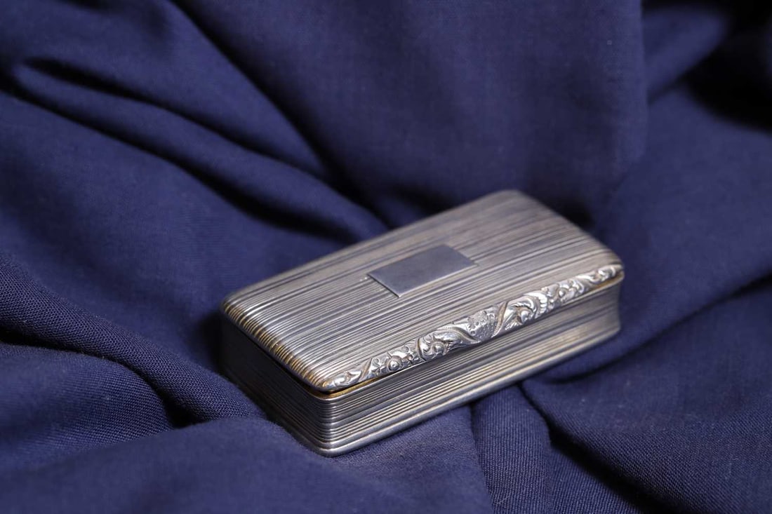 A George IV silver snuff box,: A George IV silver snuff box, by Nathaniel Mills, Birmingham 1827, with reeded decoration and a vacant cartouche, complete with a gilt interior 7cm wide, 3.8cm deep, 1.7cm