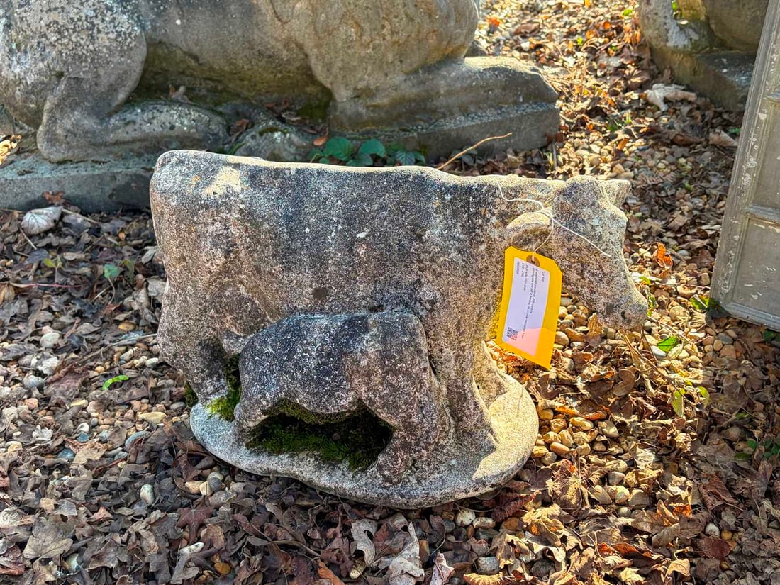 A weathered cow statue, 20th century,: A weathered cow statue, 20th century, showing cow and calf in feeding, on an oval naturalistic base 54cm wide 30cm deep