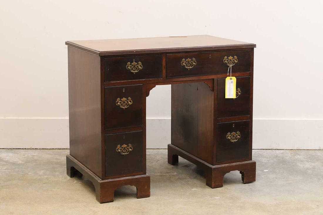 A George III crossbanded mahogany kneehole desk, (1 of 2)