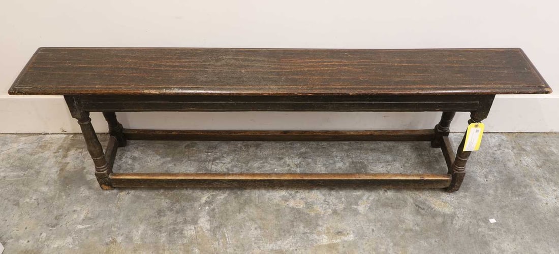 An oak and pine long bench, circa late 19th century,: An oak and pine long bench, circa late 19th century, with a moulded seat, with moulded pine frieze, on turned supports, united with stretchers 184cm wide, 29cm deep, 53.5cm high Condition Report: