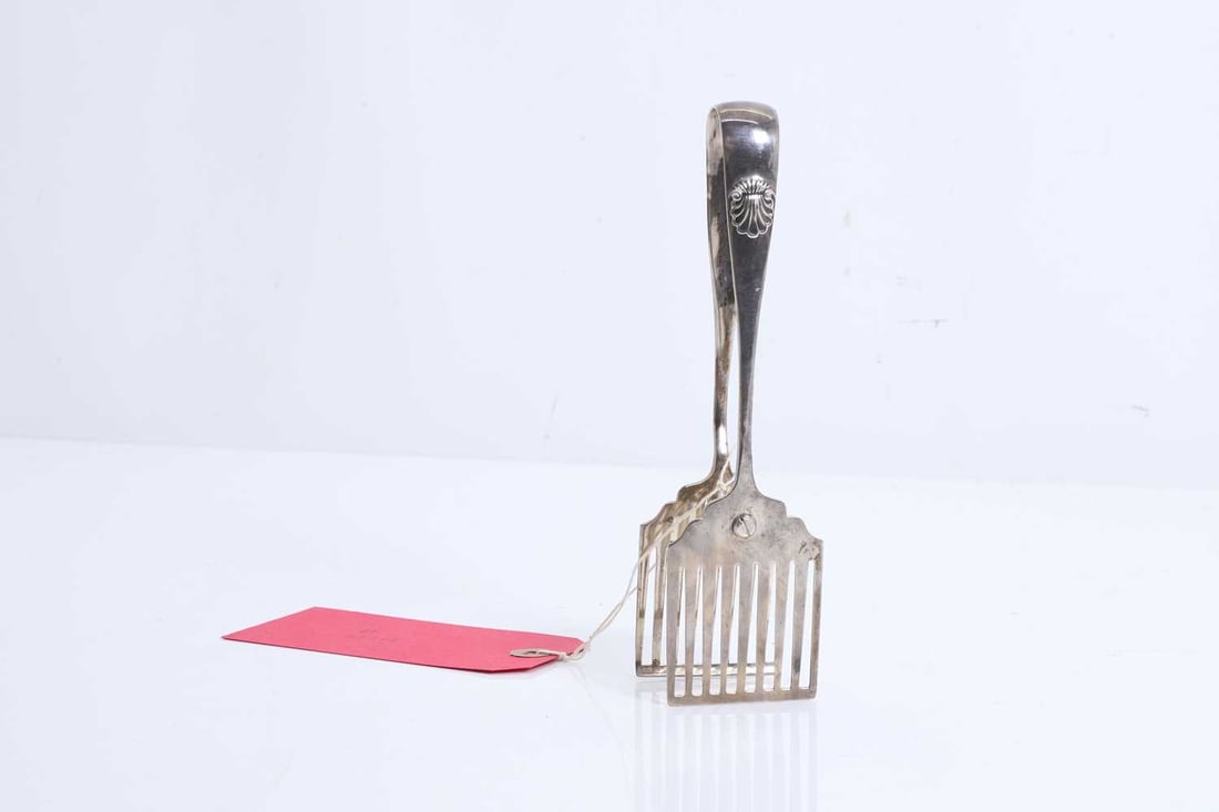 A pair of Victorian silver asparagus tongs,: A pair of Victorian silver asparagus tongs, by George Hardisty, Sheffield 1840, the handles engraved with a shell motif 3.6ozt Condition Report: Mechanisim works well. Tongs close together