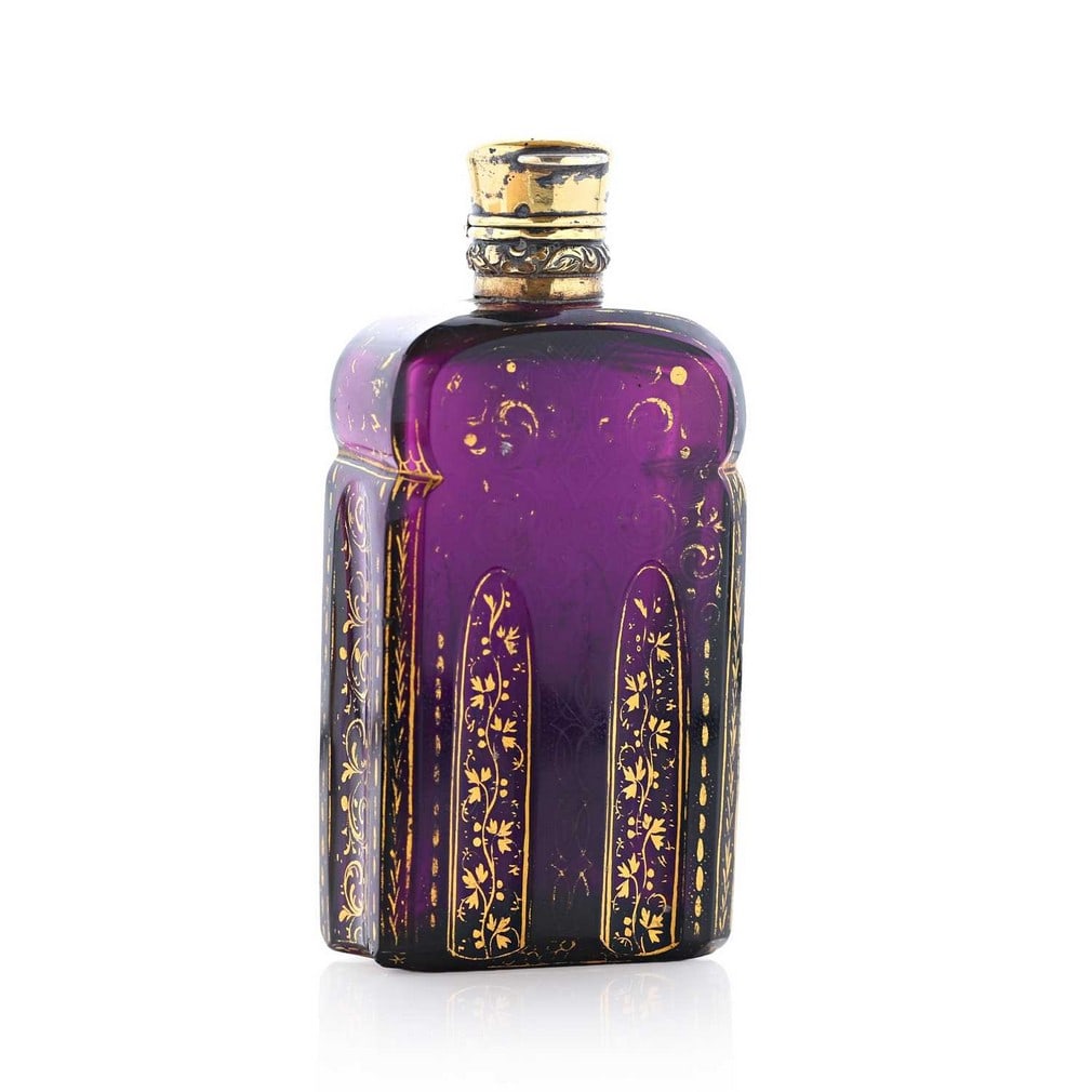 An amethyst cut-glass and gilt scent bottle, circa 1770, in the manner of James Giles,: An amethyst cut-glass and gilt scent bottle, circa 1770, in the manner of James Giles, of rectangular form with rounded shoulders and fluted columns, with foliate gilt motifs, below a French silver-gi